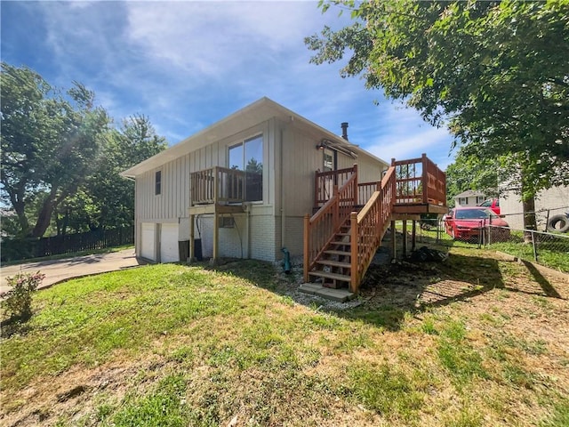 17604 E 19th Street Ct, Independence, MO 64057 - rear view of property with stairs, an attached garage, a deck, concrete driveway, and brick siding