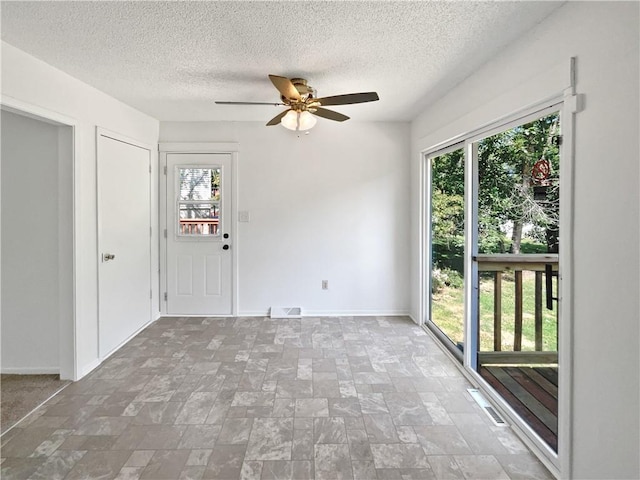17604 E 19th Street Ct, Independence, MO 64057 - entrance foyer with healthy amount of natural light, a ceiling fan, a textured ceiling, and stone finish floors