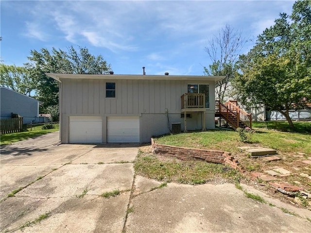 17604 E 19th Street Ct, Independence, MO 64057 - view of front of property with stairway, driveway, an attached garage, and a wooden deck