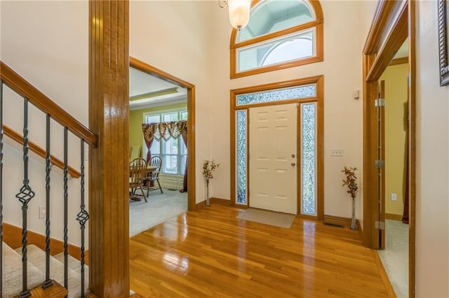 4000 SW Boulder Dr, Lees Summit, MO 64082 - foyer featuring light wood finished floors, stairway, and a towering ceiling