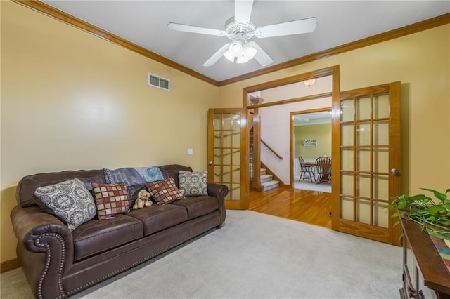 4000 SW Boulder Dr, Lees Summit, MO 64082 - carpeted living room with ornamental molding, ceiling fan, and stairway