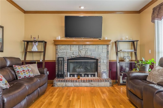 4000 SW Boulder Dr, Lees Summit, MO 64082 - living room with wood finished floors, ornamental molding, and a stone fireplace