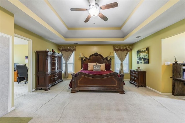 4000 SW Boulder Dr, Lees Summit, MO 64082 - bedroom featuring light carpet, a tray ceiling, multiple windows, and ceiling fan