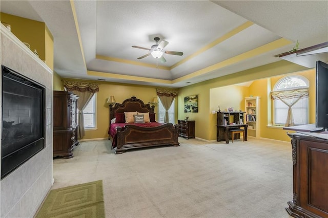 4000 SW Boulder Dr, Lees Summit, MO 64082 - bedroom featuring a tray ceiling, light carpet, and multiple windows