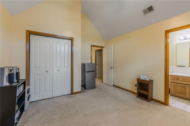 4000 SW Boulder Dr, Lees Summit, MO 64082 - bedroom featuring freestanding refrigerator, light carpet, a closet, high vaulted ceiling, and ensuite bath