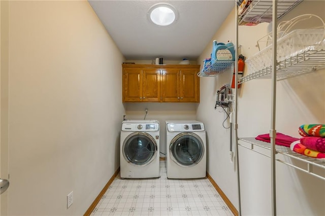 4000 SW Boulder Dr, Lees Summit, MO 64082 - laundry room with cabinet space, washing machine and clothes dryer, and light flooring