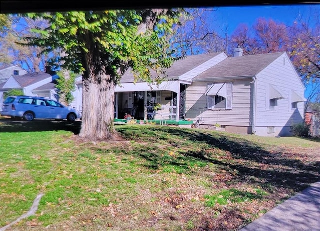 6639 Bales Ave, Kansas City, MO 64132 - view of front of home with a chimney and a front yard
