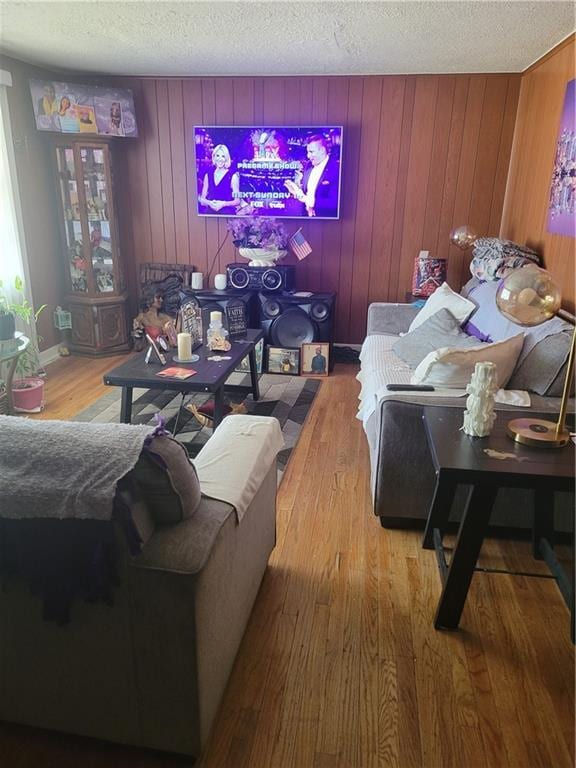 6639 Bales Ave, Kansas City, MO 64132 - living area featuring a textured ceiling, hardwood / wood-style flooring, and wooden walls