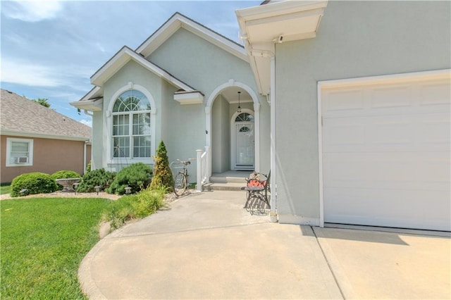 22604 Vincent St, Peculiar, MO 64078 - view of exterior entry featuring stucco siding, a garage, a yard, and driveway
