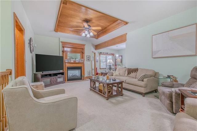 22604 Vincent St, Peculiar, MO 64078 - living room featuring a tray ceiling, ceiling fan, a glass covered fireplace, and carpet