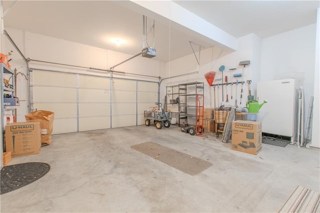 22604 Vincent St, Peculiar, MO 64078 - garage with freestanding refrigerator and a garage door opener