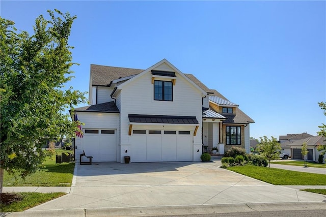 17325 Bradshaw St, Overland Park, KS 66221 - modern farmhouse featuring a standing seam roof, concrete driveway, a front lawn, an attached garage, and a metal roof