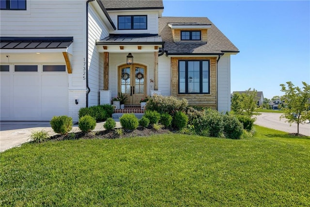 17325 Bradshaw St, Overland Park, KS 66221 - view of front of home with a garage, a front lawn, and a standing seam roof