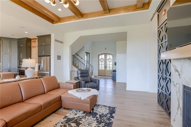 17325 Bradshaw St, Overland Park, KS 66221 - living room with beam ceiling, arched walkways, stairway, light wood-style floors, and french doors