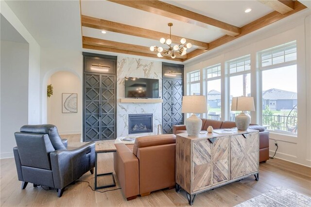 17325 Bradshaw St, Overland Park, KS 66221 - living area with light wood-type flooring, beam ceiling, a premium fireplace, a chandelier, and recessed lighting