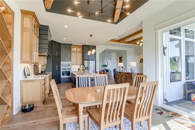 17325 Bradshaw St, Overland Park, KS 66221 - dining room with a chandelier, light wood finished floors, arched walkways, and recessed lighting