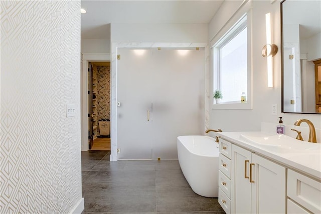 17325 Bradshaw St, Overland Park, KS 66221 - bathroom featuring vanity, a freestanding bath, and wallpapered walls