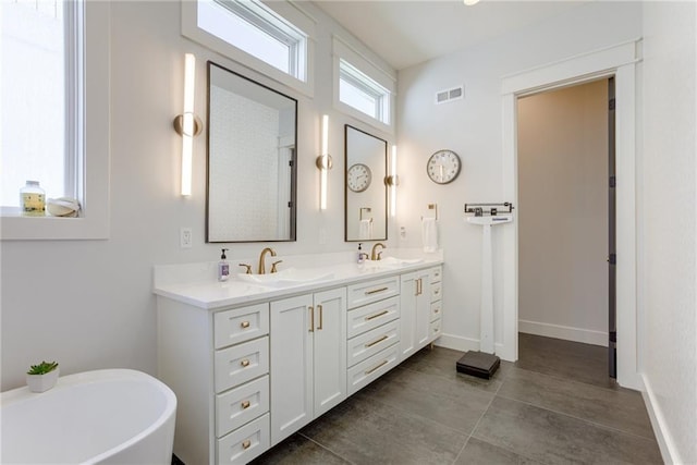 17325 Bradshaw St, Overland Park, KS 66221 - bathroom featuring double vanity, a soaking tub, and tile patterned flooring