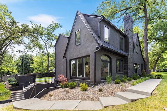 5500 Mission Rd, Fairway, KS 66205 - view of front of home featuring stucco siding, a chimney, and a shingled roof