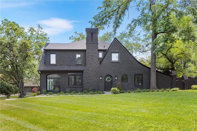 5500 Mission Rd, Fairway, KS 66205 - back of property featuring a chimney, a lawn, stucco siding, and roof with shingles