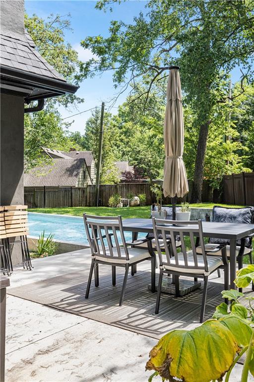 5500 Mission Rd, Fairway, KS 66205 - deck with outdoor dining area, a fenced backyard, and a patio