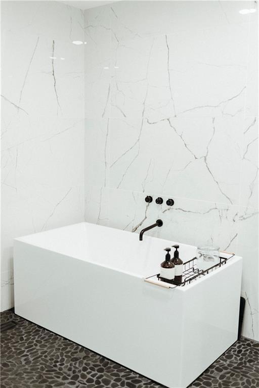 5500 Mission Rd, Fairway, KS 66205 - bathroom with tile walls and a soaking tub
