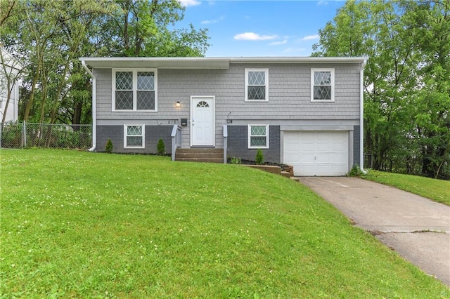 818 N Wigwam Trl, Independence, MO 64056 - raised ranch with an attached garage, concrete driveway, and entry steps