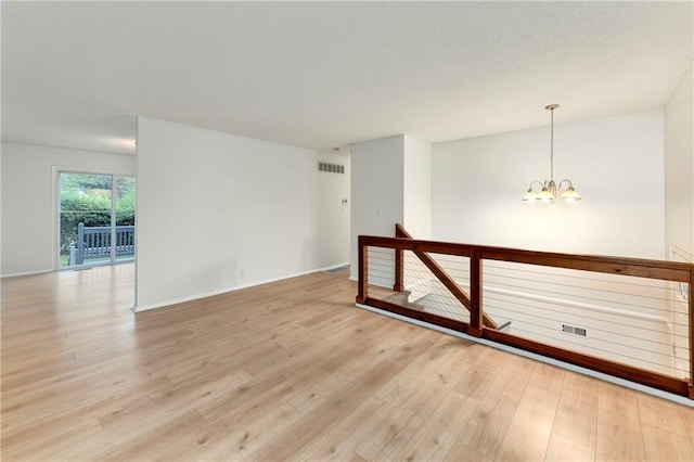 818 N Wigwam Trl, Independence, MO 64056 - spare room with a chandelier and light wood-type flooring
