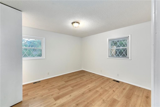 818 N Wigwam Trl, Independence, MO 64056 - spare room with light wood-type flooring and a textured ceiling