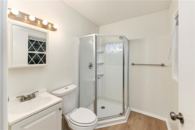818 N Wigwam Trl, Independence, MO 64056 - full bathroom with a shower stall, vanity, wood finished floors, and a textured ceiling
