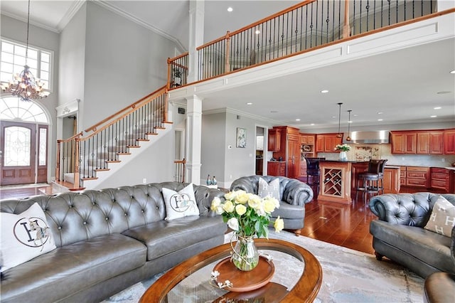12333 Westgate St, Overland Park, KS 66213 - living room featuring a towering ceiling, dark wood finished floors, ornamental molding, recessed lighting, and a chandelier