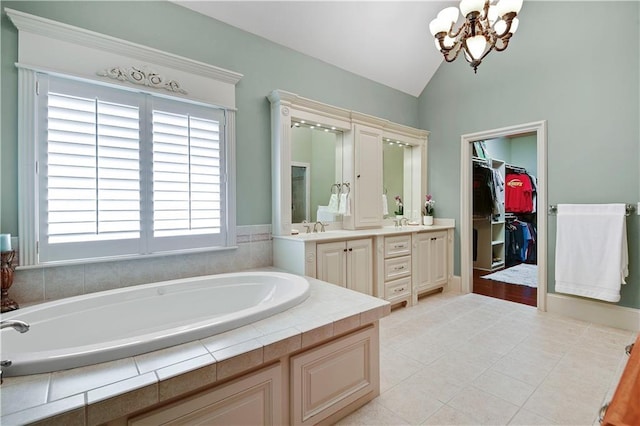 12333 Westgate St, Overland Park, KS 66213 - bathroom with a bath, a chandelier, vanity, lofted ceiling, and a spacious closet
