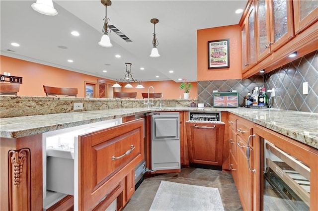 12333 Westgate St, Overland Park, KS 66213 - kitchen featuring brown cabinets, a peninsula, light stone counters, decorative backsplash, and recessed lighting