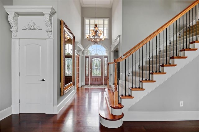 12333 Westgate St, Overland Park, KS 66213 - foyer with a chandelier, a towering ceiling, wood-type flooring, stairway, and crown molding