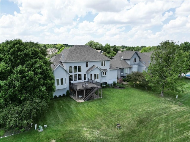12333 Westgate St, Overland Park, KS 66213 - back of house featuring stucco siding, a wooden deck, a lawn, stairway, and roof with shingles