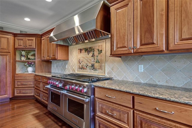 12333 Westgate St, Overland Park, KS 66213 - kitchen with double oven range, wall chimney range hood, brown cabinets, light stone counters, and ornamental molding