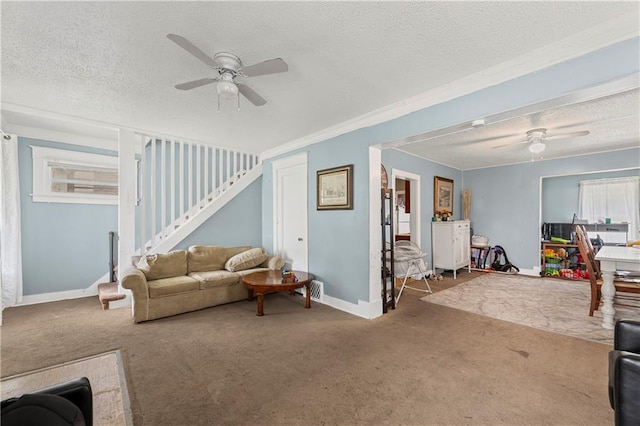 3443 Agnes Ave, Kansas City, MO 64128 - carpeted living room with a ceiling fan, a textured ceiling, stairway, and ornamental molding