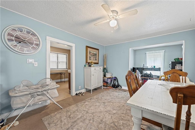 3443 Agnes Ave, Kansas City, MO 64128 - dining area with healthy amount of natural light, ceiling fan, and a textured ceiling