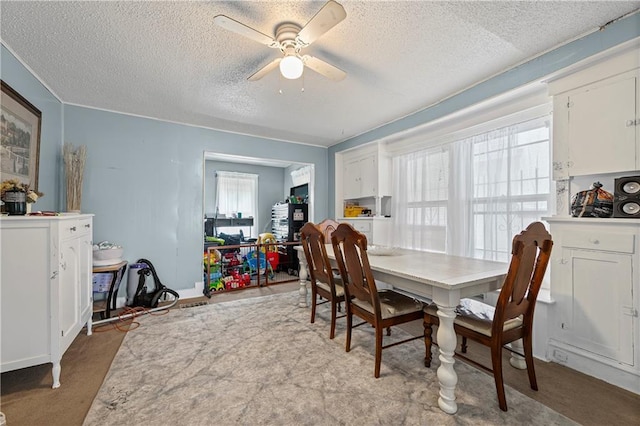 3443 Agnes Ave, Kansas City, MO 64128 - carpeted dining space featuring a textured ceiling and ceiling fan
