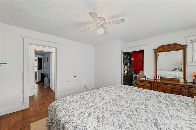 3443 Agnes Ave, Kansas City, MO 64128 - bedroom with dark wood-style floors, a textured ceiling, and a ceiling fan