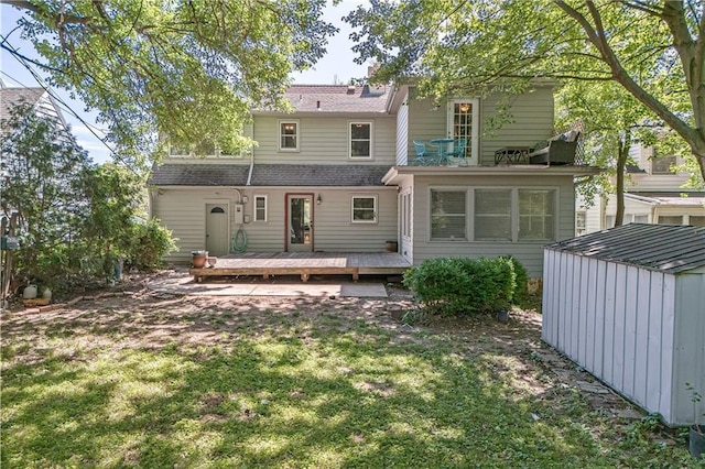 2010 Eugene Field Ave, Saint Joseph, MO 64505 - back of property with a storage shed, a wooden deck, and a lawn