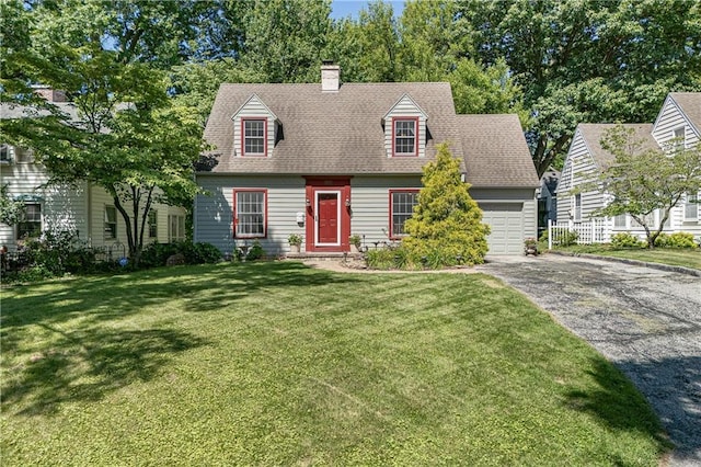 2010 Eugene Field Ave, Saint Joseph, MO 64505 - cape cod house with a garage, driveway, a front lawn, and a chimney