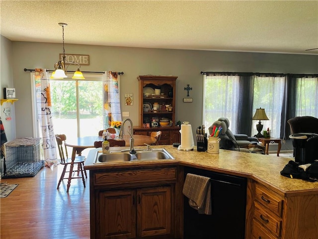 17540 W 159th Ct, Olathe, KS 66062 - kitchen with dishwasher, open floor plan, plenty of natural light, light countertops, and a textured ceiling