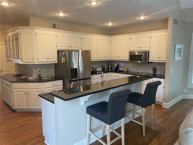 14301 Beverly St, Overland Park, KS 66223 - kitchen featuring stainless steel appliances, dark wood-style flooring, white cabinets, and recessed lighting