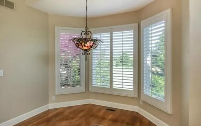 14301 Beverly St, Overland Park, KS 66223 - unfurnished dining area with dark wood finished floors and healthy amount of natural light