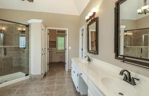 14301 Beverly St, Overland Park, KS 66223 - full bath with double vanity, a stall shower, and tile patterned flooring
