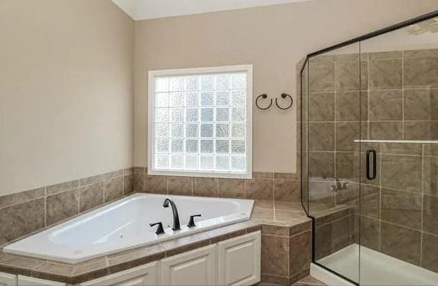 14301 Beverly St, Overland Park, KS 66223 - bathroom with a bath and a shower stall
