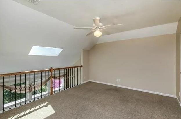 14301 Beverly St, Overland Park, KS 66223 - bonus room featuring ceiling fan, a skylight, lofted ceiling, and carpet flooring