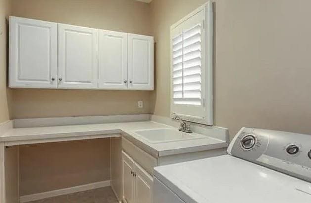 14301 Beverly St, Overland Park, KS 66223 - laundry area featuring washer / clothes dryer and cabinet space