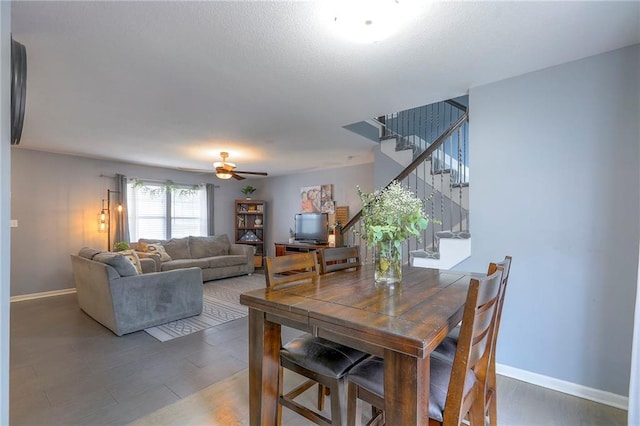 503 SW Creek Ridge Dr, Grain Valley, MO 64029 - dining space featuring stairway, a ceiling fan, and wood finished floors